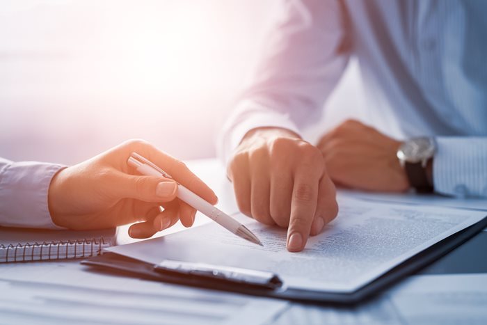 Two attorneys reviewing paperwork together