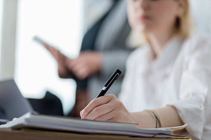 Female attorney reading details about general liability insurance for lawyers.